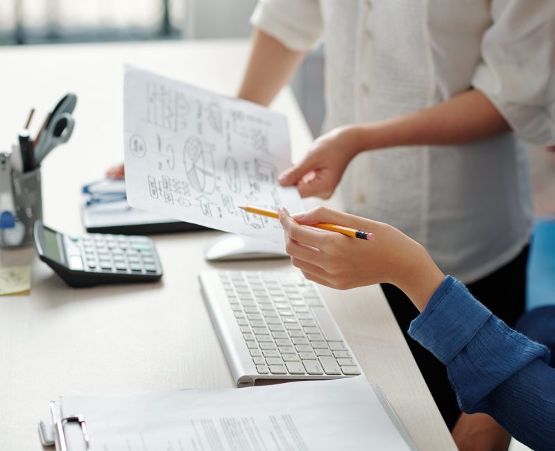 Businessman showing coworker chart illustarting company development ideas